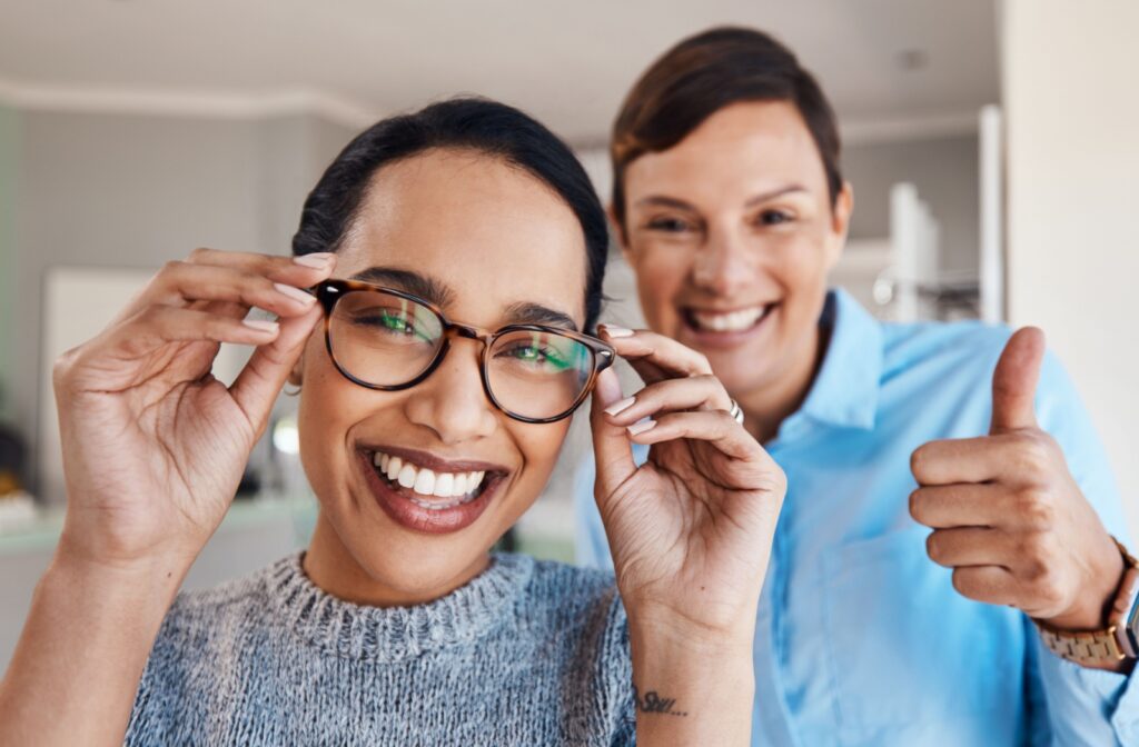 A patient smiling with their eye doctor after choosing new progressive eyeglasses.