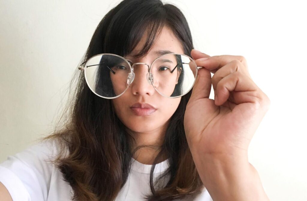 A woman with myopia trying on a new pair of glasses.