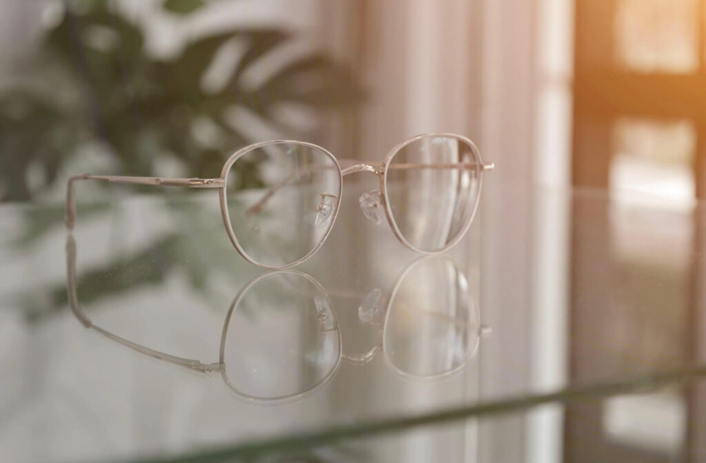 A pair of progressive lens glasses resting on a table.